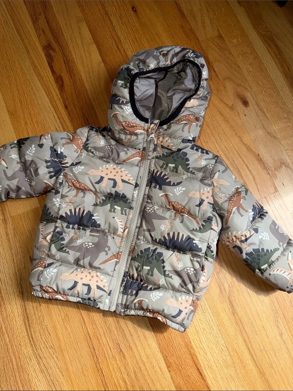 The Children's Place Dino Hooded Puffer Jacket in Tan, Green & Navy